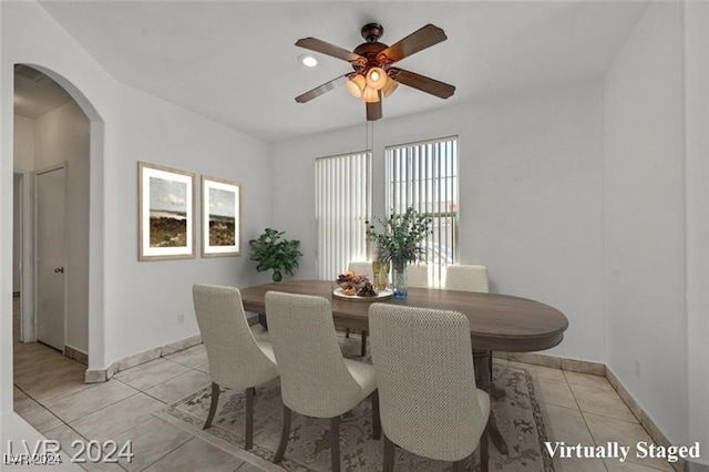 dining area featuring light tile patterned floors, plenty of natural light, and ceiling fan