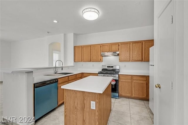 kitchen with dishwashing machine, gas range, sink, a kitchen island, and light tile patterned flooring