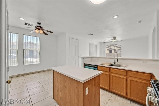 kitchen with a center island, sink, a wealth of natural light, and stainless steel range with gas stovetop