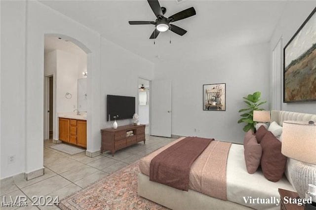 bedroom featuring connected bathroom, ceiling fan, and light tile patterned flooring