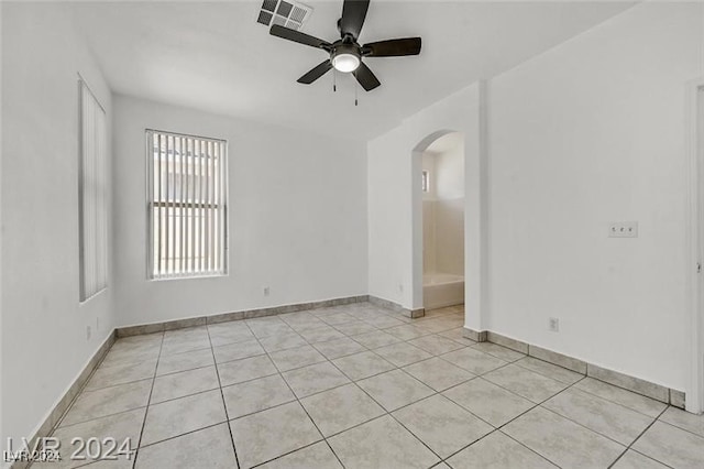 tiled empty room with ceiling fan