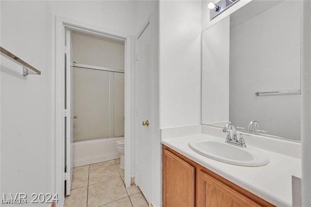 full bathroom featuring combined bath / shower with glass door, vanity, tile patterned floors, and toilet