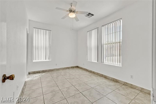 empty room with light tile patterned floors and ceiling fan