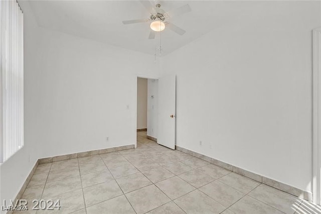 spare room featuring ceiling fan and light tile patterned floors