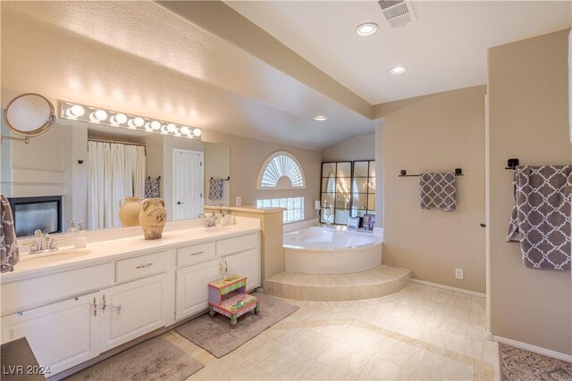 1819 Wild Indigo Ct, Las Vegas, NV 89123 - bathroom with a bath, double vanity, vaulted ceiling, and recessed lighting