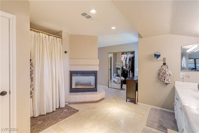 bathroom featuring vanity and a fireplace