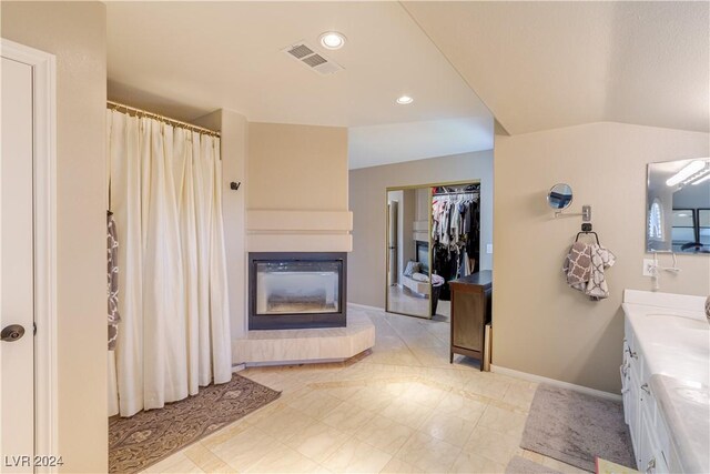 1819 Wild Indigo Ct, Las Vegas, NV 89123 - full bathroom with a glass covered fireplace, vanity, recessed lighting, a shower with curtain, and tile patterned floors
