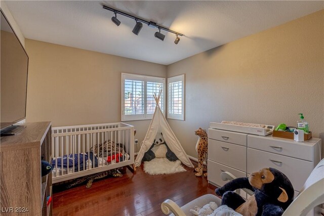 1819 Wild Indigo Ct, Las Vegas, NV 89123 - bedroom with track lighting and wood-type flooring