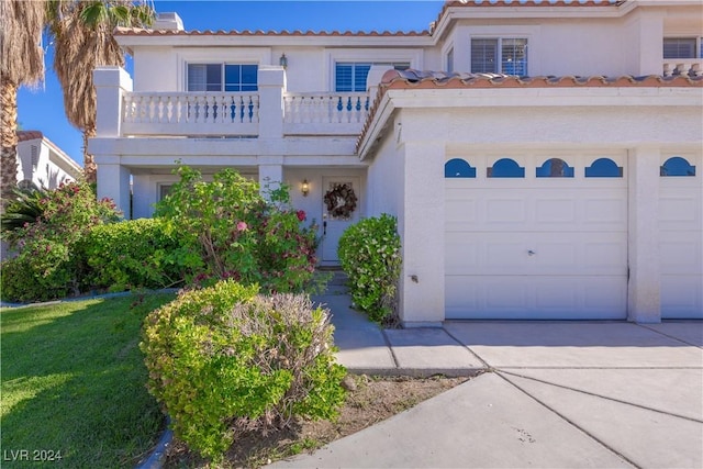 1819 Wild Indigo Ct, Las Vegas, NV 89123 - mediterranean / spanish home with a balcony, stucco siding, and driveway