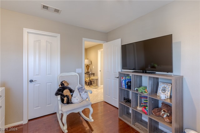 playroom featuring dark wood-type flooring