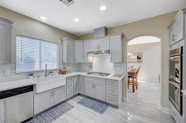 kitchen featuring gray cabinetry and stainless steel appliances