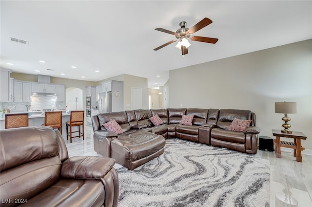 living room with ceiling fan and light hardwood / wood-style flooring