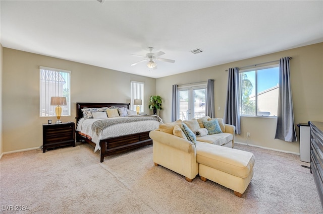 bedroom featuring light carpet and ceiling fan