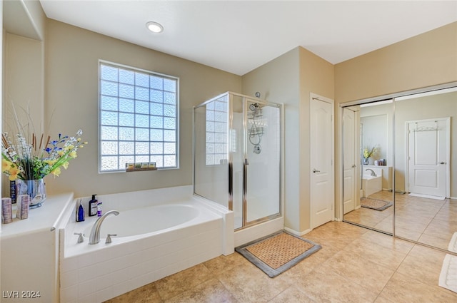 bathroom with tile patterned floors and separate shower and tub