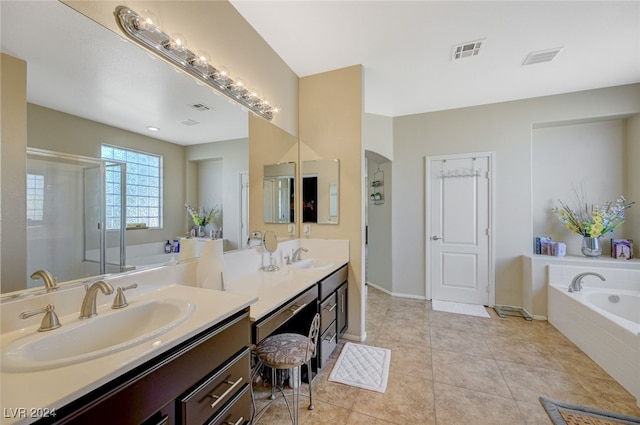 bathroom with tile patterned flooring, vanity, and shower with separate bathtub