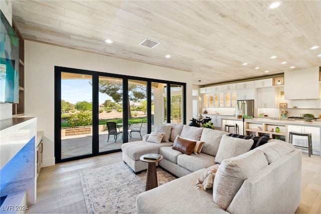 living room with sink, light wood-type flooring, and wood ceiling