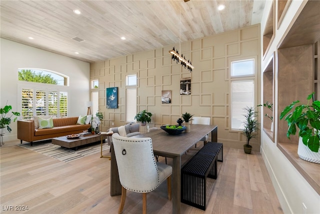 dining room with wooden ceiling and light hardwood / wood-style floors