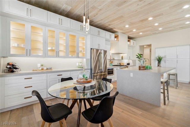 kitchen with light hardwood / wood-style floors, white cabinetry, and high quality fridge