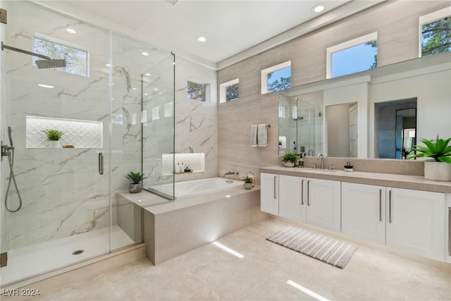 bathroom with tile patterned floors, vanity, and independent shower and bath