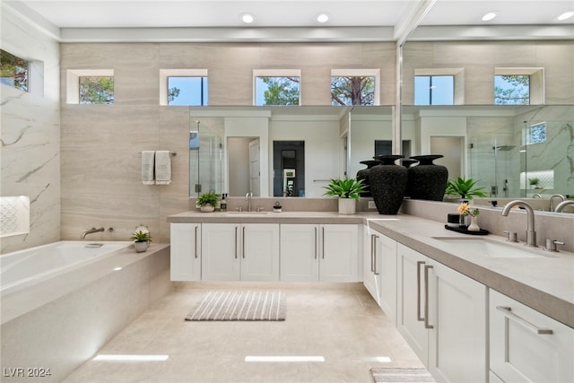 bathroom with tile patterned floors, vanity, and plus walk in shower