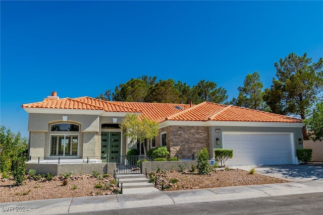 mediterranean / spanish-style house with a garage