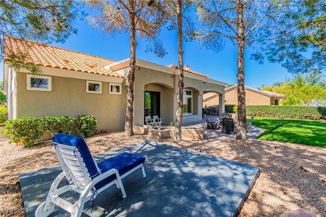 rear view of property with a patio area and a yard