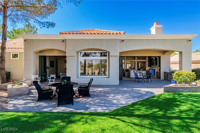 rear view of house with a patio area and a lawn