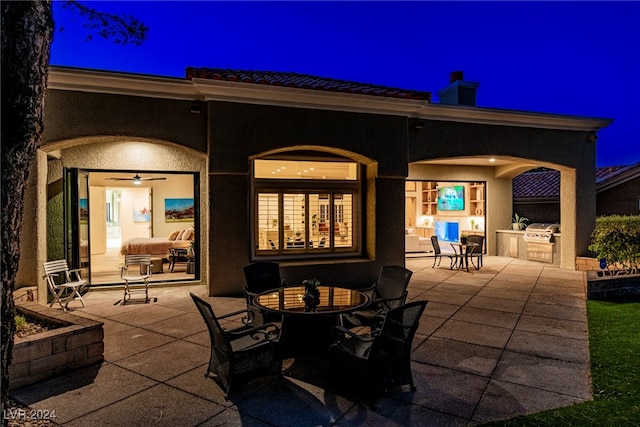 patio at twilight featuring area for grilling