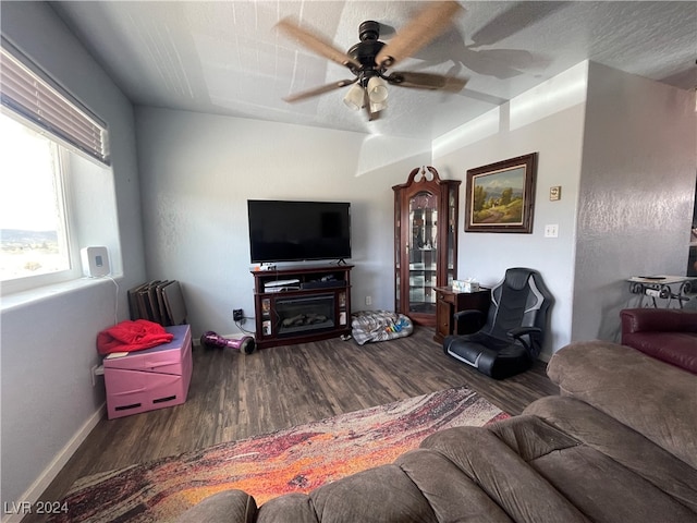 living room featuring hardwood / wood-style floors and ceiling fan