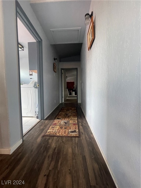 hall featuring dark hardwood / wood-style flooring and independent washer and dryer