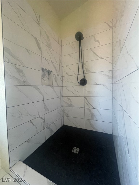 bathroom with a tile shower