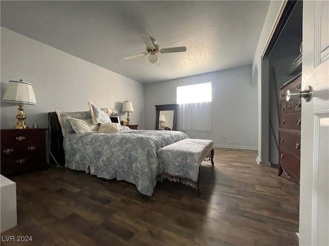 bedroom featuring a textured ceiling, ceiling fan, and dark hardwood / wood-style floors