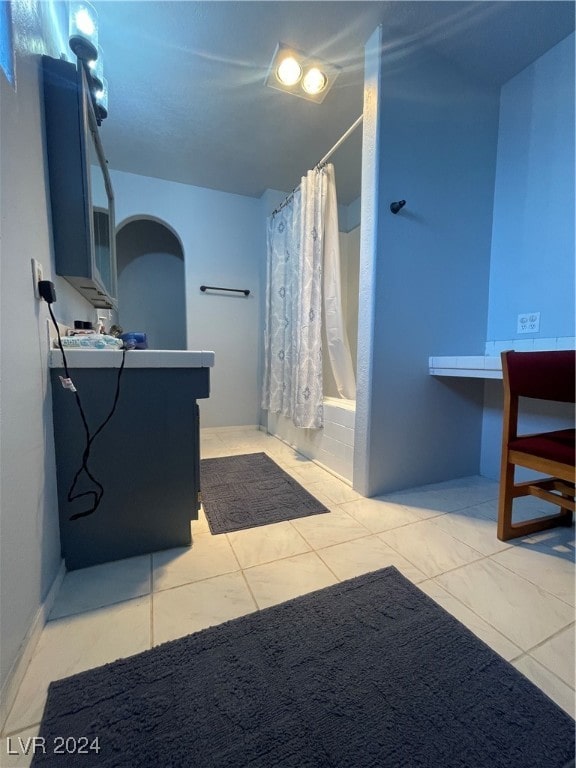 bathroom featuring tile patterned floors, vanity, and shower / tub combo