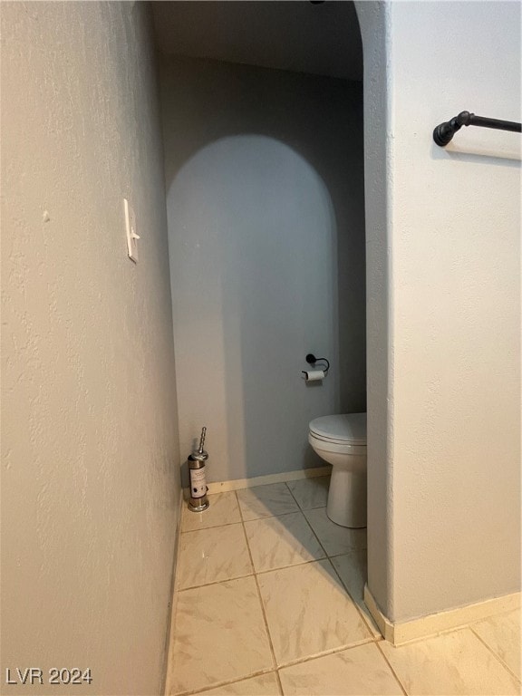 bathroom featuring tile patterned floors and toilet