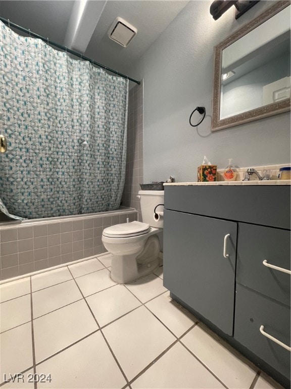 full bathroom featuring tile patterned floors, shower / bath combo with shower curtain, vanity, and toilet