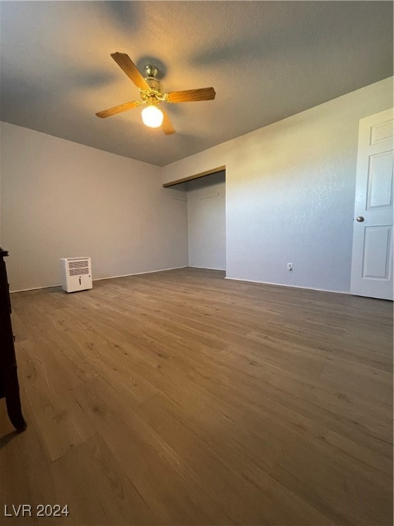 empty room with wood-type flooring, a textured ceiling, and ceiling fan