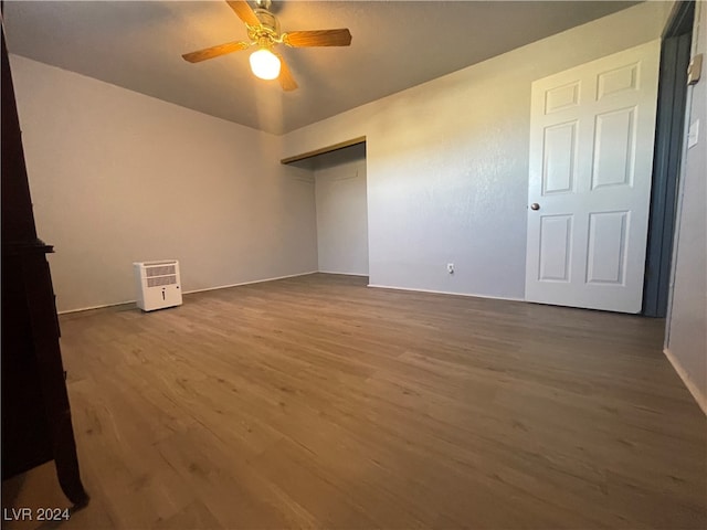 unfurnished bedroom with ceiling fan and wood-type flooring