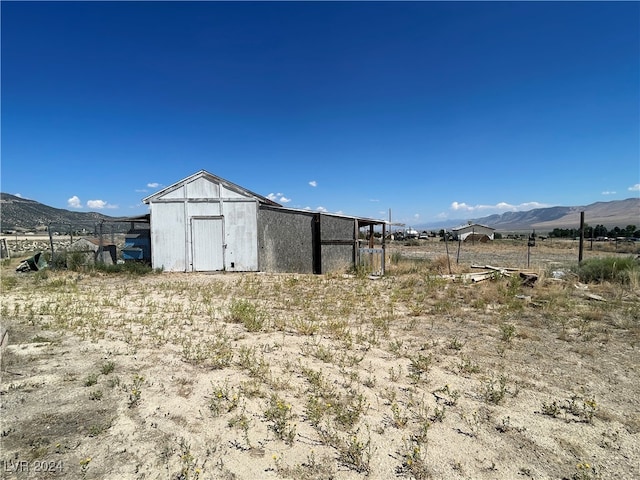 view of outbuilding with a mountain view and a rural view