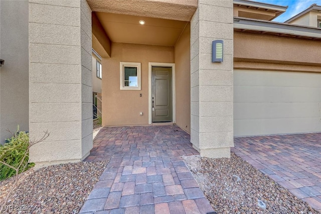 view of exterior entry featuring a garage