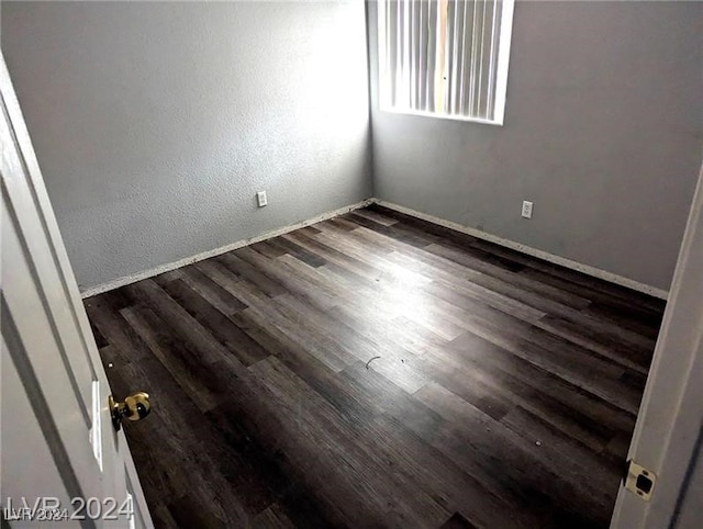 empty room with dark hardwood / wood-style floors