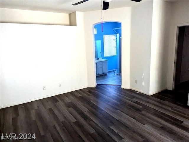 empty room featuring ceiling fan and dark hardwood / wood-style flooring