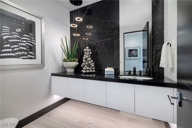 bathroom with hardwood / wood-style floors and vanity