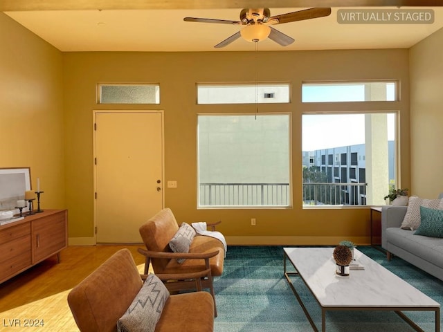 living room with ceiling fan and light hardwood / wood-style floors