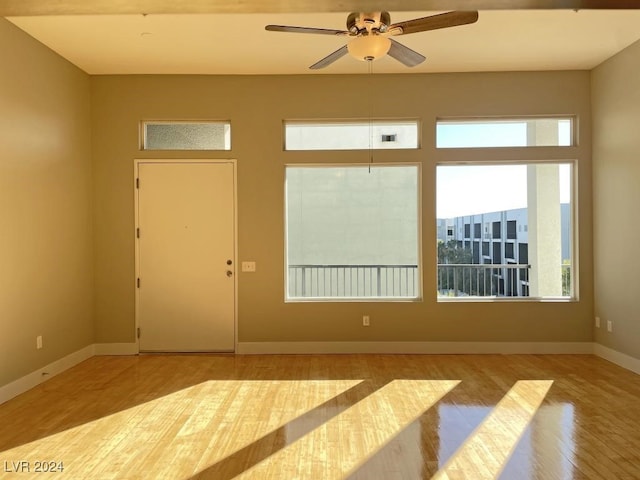 empty room with light hardwood / wood-style flooring and ceiling fan