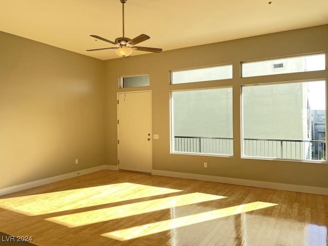 unfurnished room featuring light hardwood / wood-style floors and ceiling fan