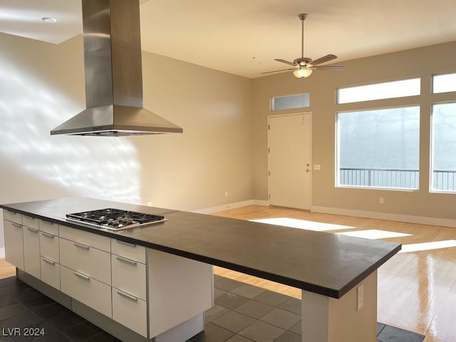 2715 W Pebble Rd Unit 505, Las Vegas, NV 89123 - kitchen featuring island range hood, dark countertops, stainless steel gas cooktop, and a kitchen island