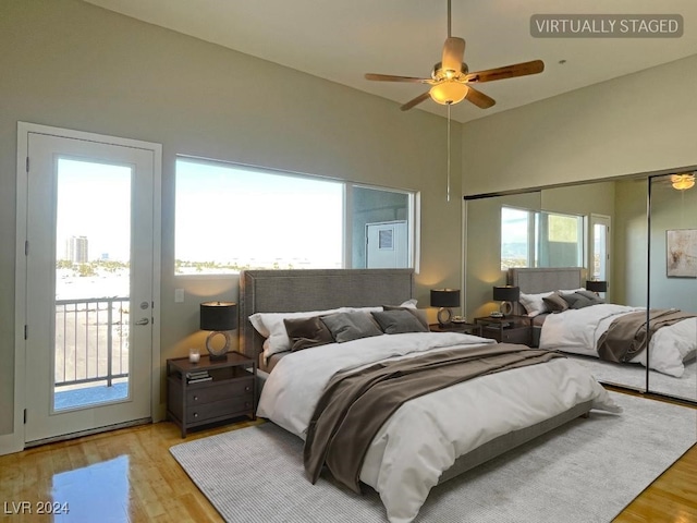 bedroom featuring access to outside, multiple windows, light hardwood / wood-style floors, and ceiling fan