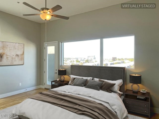 bedroom featuring light hardwood / wood-style flooring, ceiling fan, and lofted ceiling