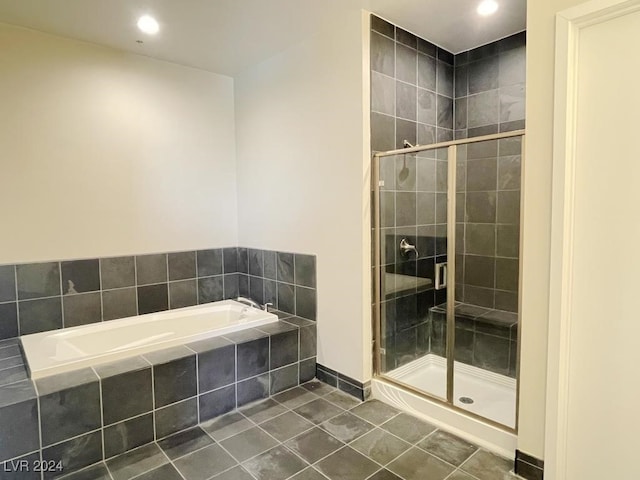 bathroom with tile patterned flooring and separate shower and tub