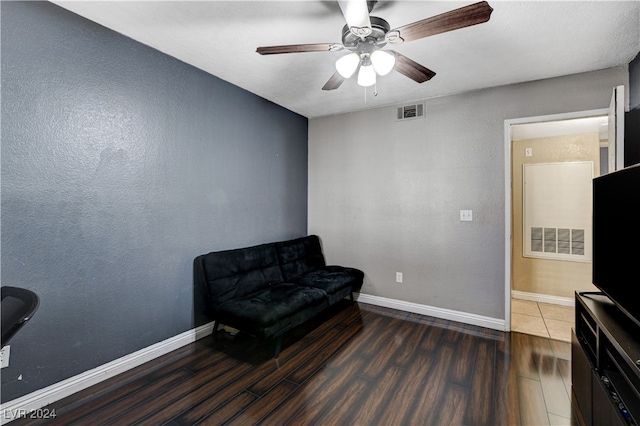 living area with dark hardwood / wood-style floors and ceiling fan